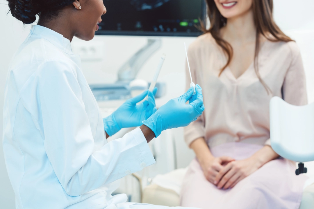 Healthcare provider prepares for exam—confidential care and screenings available at your local STD Clinic.
