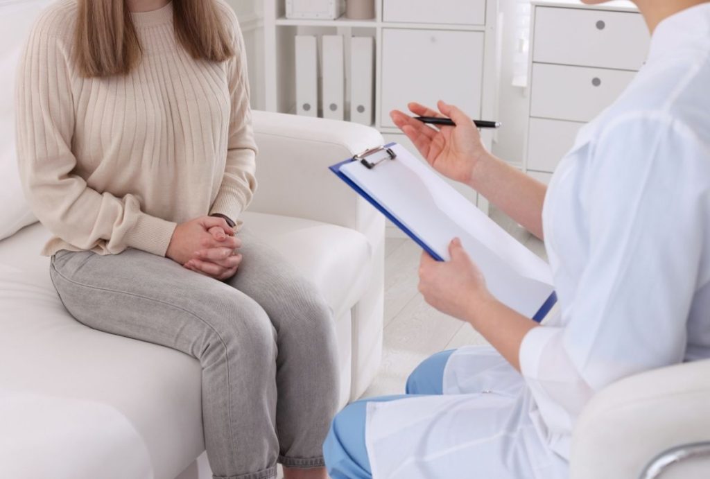 Patient consultation with clinician in office, discussing sexual health and confidential options for affordable std testing houston