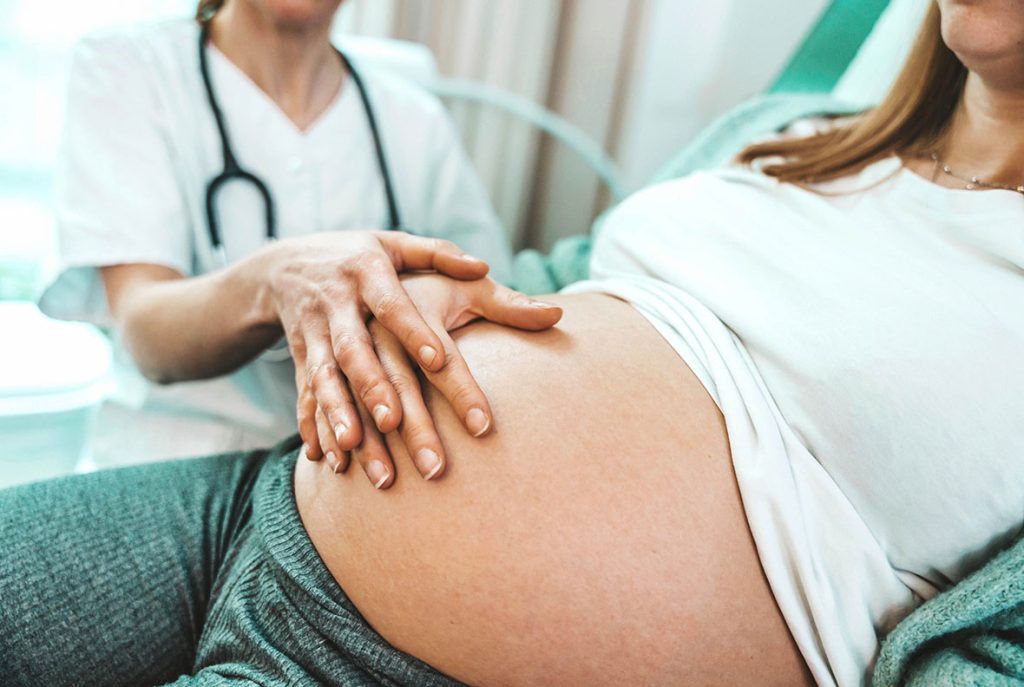 Close up of a healthcare provider performing a prenatal exam for a patient seeking STD treatment Houston.