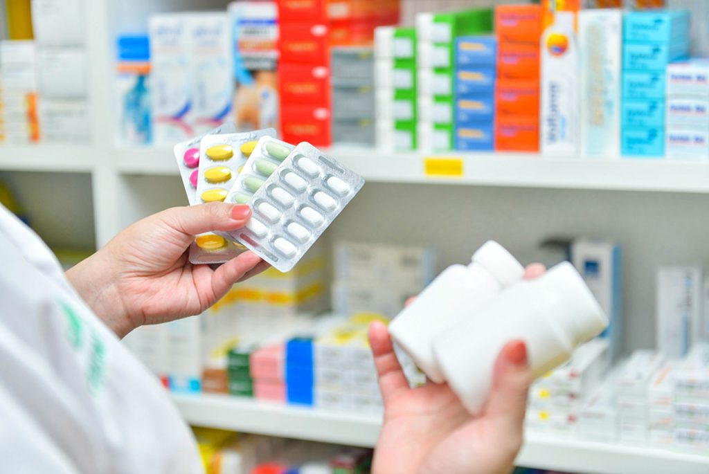 Healthcare worker presenting various prescription options for STD medication Houston clinics provide for patient care.