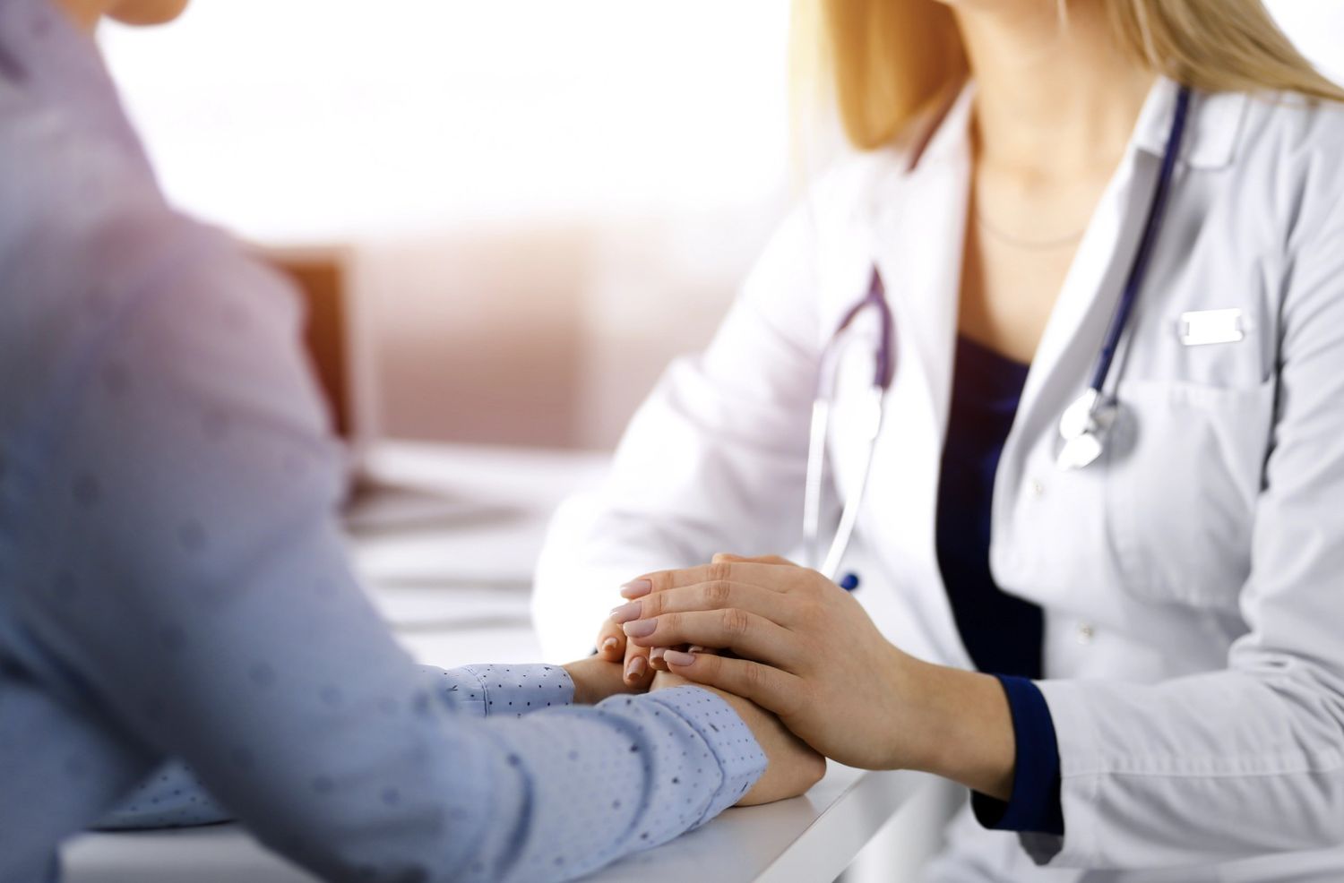 Doctor holding patient's hands for reassurance, emphasizing compassionate care at the STD testing clinic in Houston
