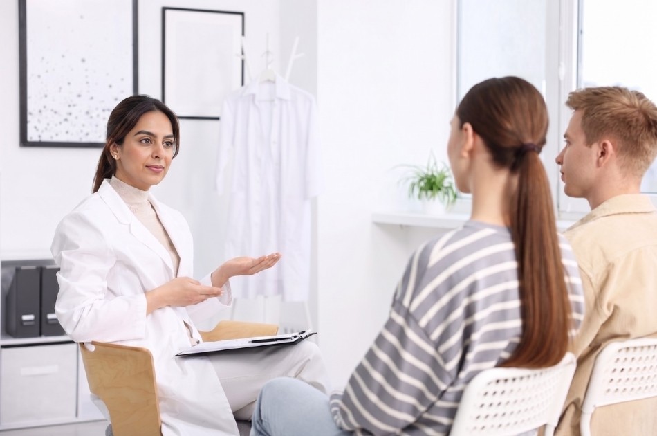 Dr. Anita Leal discussing private sexual health treatment plans with a young couple at an STD clinic